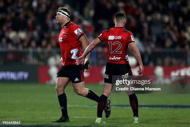 Ryan Crotty of the Crusaders acknowledges Wyatt Crockett as he runs out onto the field for his 200th appearance for the Crusaders during the round 18...