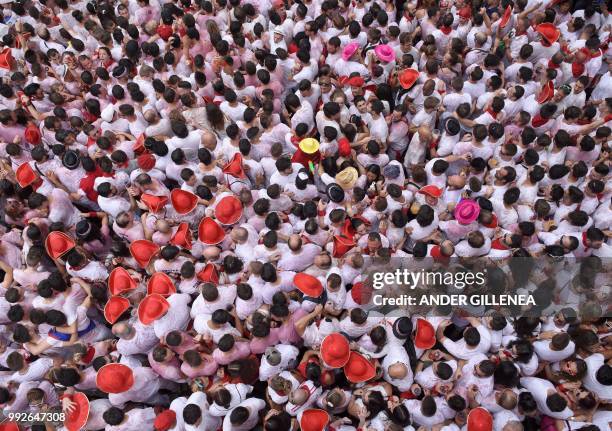 Participants celebrate during the 'Chupinazo' to mark the kickoff at noon sharp of the San Fermin Festival, in front of the Town Hall of Pamplona,...