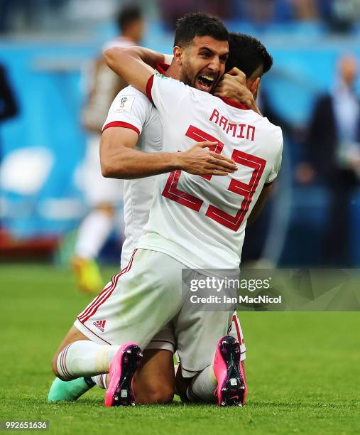 Mohammad Reza Khanzadeh and Ramin Rezaeian of Iran celebrate at full time during the 2018 FIFA World Cup Russia group B match between Morocco and...