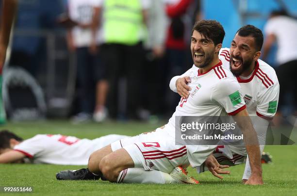 Karim Ansarifard and Rouzbeh Cheshmi of Iran celebrate at full time during the 2018 FIFA World Cup Russia group B match between Morocco and Iran at...
