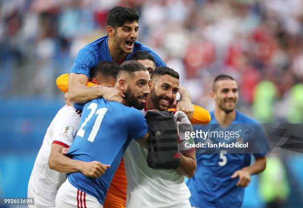 Saman Ghoddos of Iran celebrates with team mates at full time during the 2018 FIFA World Cup Russia group B match between Morocco and Iran at Saint...