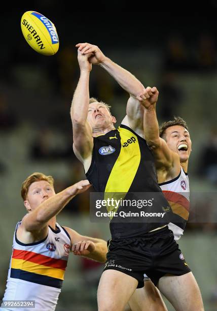 Jack Riewoldt of the Tigers competes for a mark with Daniel Talia of the Crows during the round 16 AFL match between the Richmond Tigers and the...