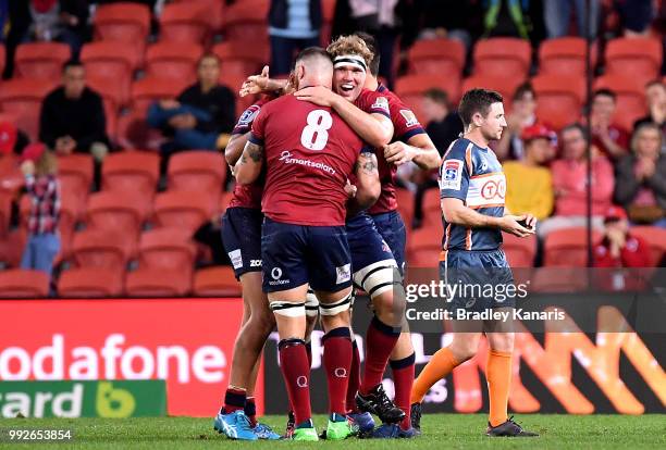 Scott Higginbotham of the Reds celebrates victory with team mates after the round 18 Super Rugby match between the Reds and the Rebels at Suncorp...