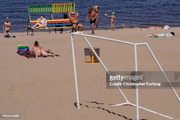 Russians sunbathe on the beach next to the River Volga on July 6, 2018 in Samara, Russia. Football fans from England and Sweden are arriving in...