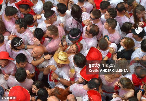 Participants celebrate during the 'Chupinazo' to mark the kickoff at noon sharp of the San Fermin Festival, in front of the Town Hall of Pamplona,...