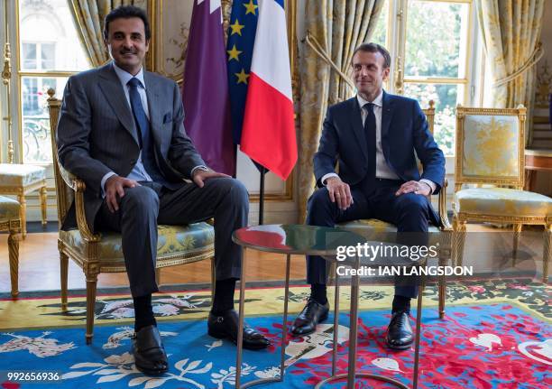 French President Emmanuel Macron attends a meeting with the Emir of Qatar Sheikh Tamim bin Hamad Al Thani at the Elysee Presidential Palace in Paris...