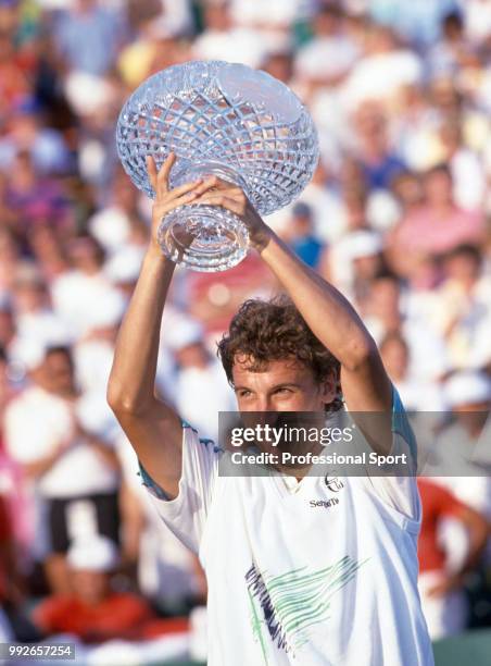 Mats Wilander of Sweden lifts the trophy after defeating Jimmy Connors of the USA in the Men's Singles Final of the Lipton International Players...