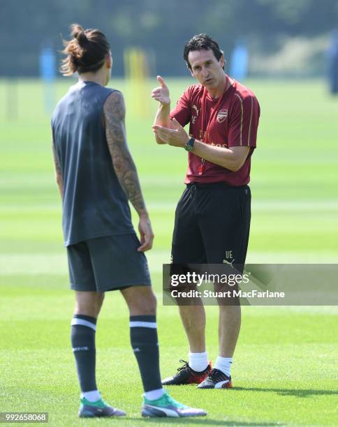 Arsenal Head Coach Unai Emery with Hector Bellerin during a training session at London Colney on July 6, 2018 in St Albans, England.