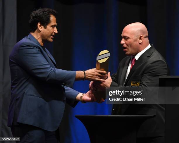 Matt Serra's coach Ray Longo hands him a trophy after inducting him into the UFC Hall of Fame at The Pearl concert theater at Palms Casino Resort on...