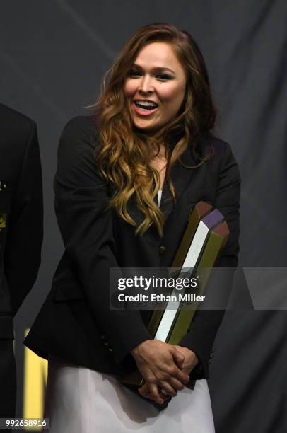 Ronda Rousey holds a trophy onstage after becoming the first female inducted into the UFC Hall of Fame at The Pearl concert theater at Palms Casino...