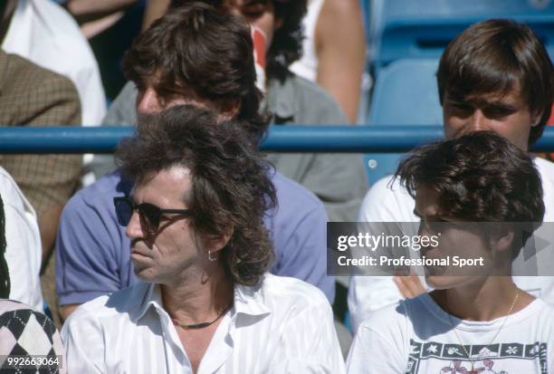 Rolling Stones guitarist Keith Richards and Sonya Mulholland, wife of Mats Wilander, watch Wilander playing a match during the US Open at the USTA...