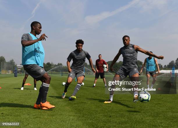 Eddie Nketiah, Reiss Nelson and Chuba AKpom of Arsenal during a training session at London Colney on July 6, 2018 in St Albans, England.