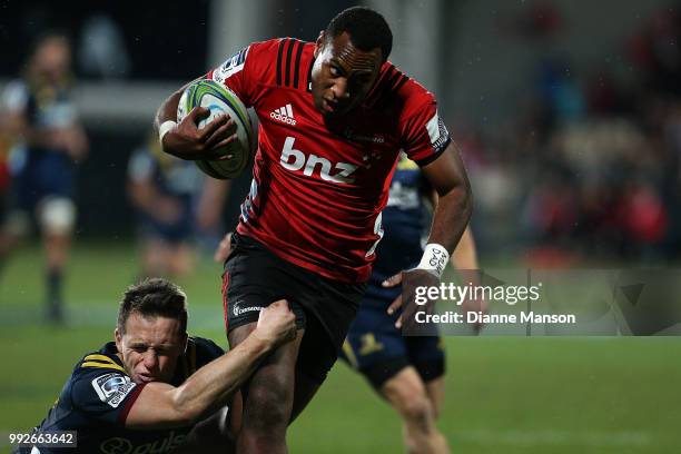 Manasa Mataele of the Crusaders is tackled by Ben Smith of the Highlanders during the round 18 Super Rugby match between the Crusaders and the...