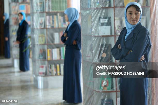 Afghan women stand to welcome guests at the Naser Khusro Balkhi Library during an opening ceremony in Kabul on June 6, 2011. The Naser Khusro Balkhi...