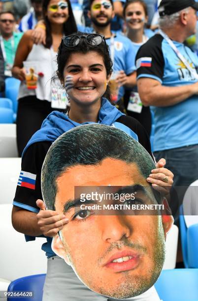 An Uruguay supporter poses with a cardboard cut out depicting Uruguay's forward Luis Suarez before the Russia 2018 World Cup quarter-final football...