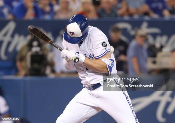 Randal Grichuk of the Toronto Blue Jays is hit by pitch in the eighth inning during MLB game action against the New York Mets at Rogers Centre on...