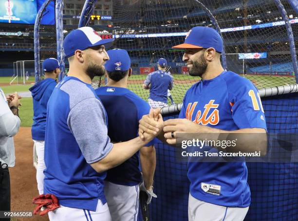 Jose Bautista of the New York Mets greets former teammate Kevin Pillar of the Toronto Blue Jays before the start of their MLB game at Rogers Centre...