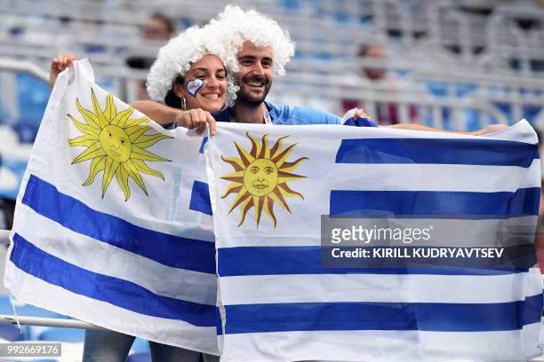 Uruguay's fans pose with national flags before the Russia 2018 World Cup quarter-final football match between Uruguay and France at the Nizhny...
