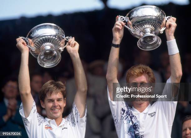 Todd Woodbridge and Mark Woodforde both of Australia lift their trophies after defeating Grant Connell of Canada and Patrick Galbraith of the USA in...