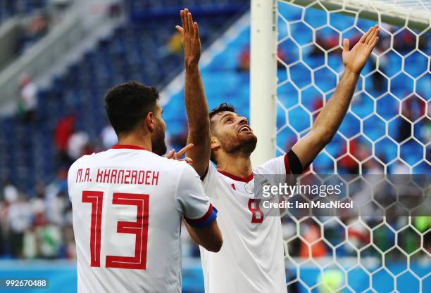 Mohammad Reza Khanzadeh of Iran and Morteza Pouraliganji of Iran celebrate during the 2018 FIFA World Cup Russia group B match between Morocco and...