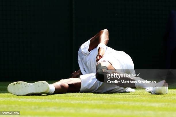 Gael Monfils of France reacts after falling to the court against Sam Querrey of the United States during their Men's Singles third round match on day...