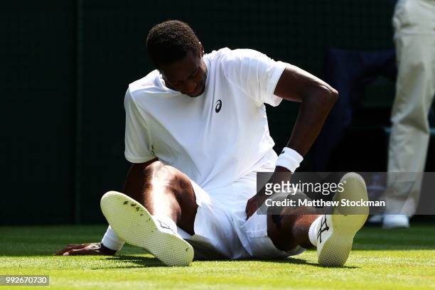 Gael Monfils of France reacts after falling to the court against Sam Querrey of the United States during their Men's Singles third round match on day...