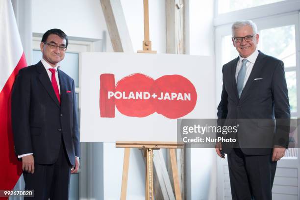 Japanese Foreign Minister Taro Kono and Polish Foreign Minister Jacek Czaputowicz present the logo of the 100th anniversary of the establishment of...