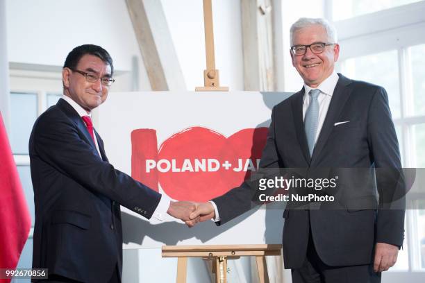 Japanese Foreign Minister Taro Kono and Polish Foreign Minister Jacek Czaputowicz present the logo of the 100th anniversary of the establishment of...