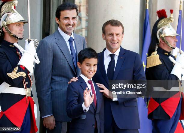 French President Emmanuel Macron welcomes Qatar's Emir Sheik Tamim bin Hamad al-Thani and his son Hamad prior to their meeting at the Elysee...