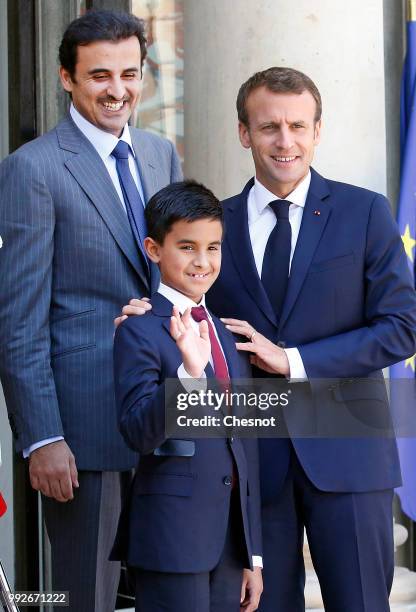 French President Emmanuel Macron welcomes Qatar's Emir Sheik Tamim bin Hamad al-Thani and his son Hamad prior to their meeting at the Elysee...