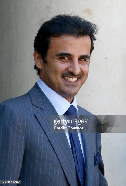 Qatar's Emir Sheik Tamim bin Hamad al-Thani smiles as he arrives at the Elysee Presidential Palace for a meeting with French President Emmanuel...