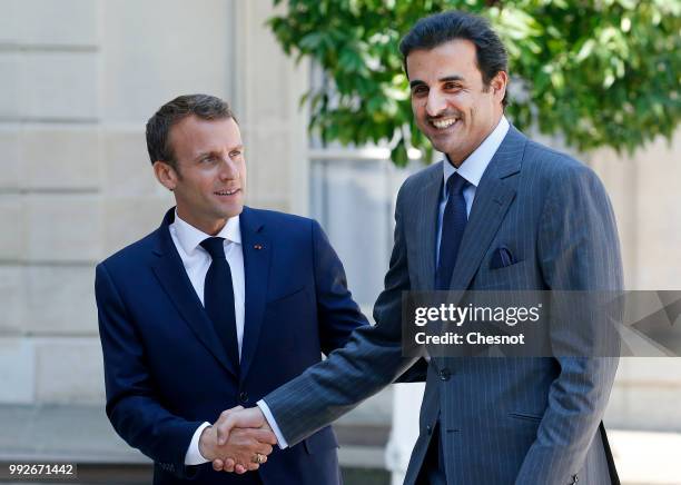 French President Emmanuel Macron welcomes Qatar's Emir Sheik Tamim bin Hamad al-Thani prior to a meeting at the Elysee Presidential Palace on July...