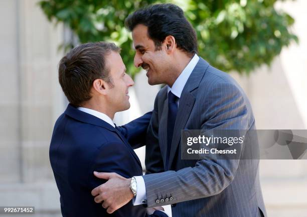 French President Emmanuel Macron welcomes Qatar's Emir Sheik Tamim bin Hamad al-Thani prior to a meeting at the Elysee Presidential Palace on July...