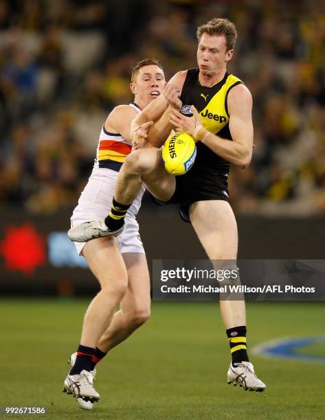 Dylan Grimes of the Tigers and Tom Lynch of the Crows compete for the ball during the 2018 AFL round 16 match between the Richmond Tigers and the...