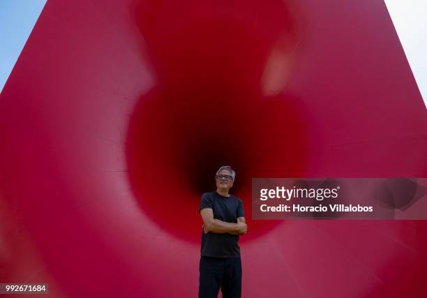 Indian artist Anish Kapoor stands in front of his work "Sectional Body Preparing for Monadic Singularity" during the presentation to the press of his...