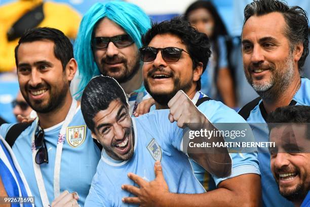 Uruguay supporters pose with a cardboard cut out depicting Uruguay's forward Luis Suarez before the Russia 2018 World Cup quarter-final football...