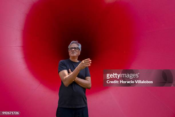 Indian artist Anish Kapoor briefs visiting journalists in front of his work "Sectional Body Preparing for Monadic Singularity" during the...