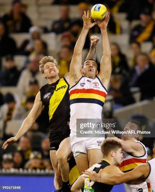 Taylor Walker of the Crows and Nathan Broad of the Tigers compete for the ball during the 2018 AFL round 16 match between the Richmond Tigers and the...