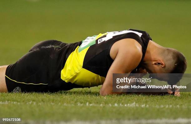Jack Graham of the Tigers reacts after a shoulder injury during the 2018 AFL round 16 match between the Richmond Tigers and the Adelaide Crows at the...