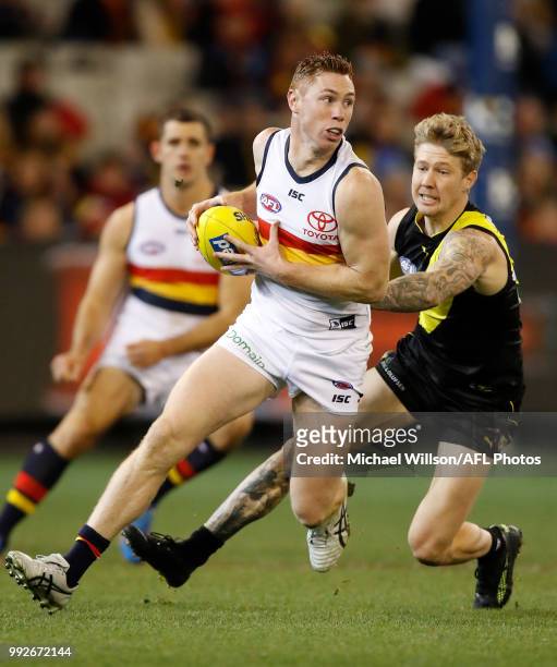 Tom Lynch of the Crows runs with the ball during the 2018 AFL round 16 match between the Richmond Tigers and the Adelaide Crows at the Melbourne...