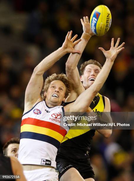 Rory Sloane of the Crows and Dylan Grimes of the Tigers compete for the ball during the 2018 AFL round 16 match between the Richmond Tigers and the...