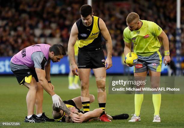 Nathan Broad of the Tigers lays injured during the 2018 AFL round 16 match between the Richmond Tigers and the Adelaide Crows at the Melbourne...