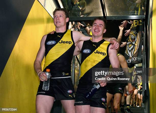 Dylan Grimes and Jack Higgins of the Tigers celebrate winning the round 16 AFL match between the Richmond Tigers and the Adelaide Crows at Melbourne...