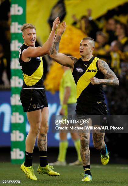 Josh Caddy and Dustin Martin of the Tigers celebrate during the 2018 AFL round 16 match between the Richmond Tigers and the Adelaide Crows at the...