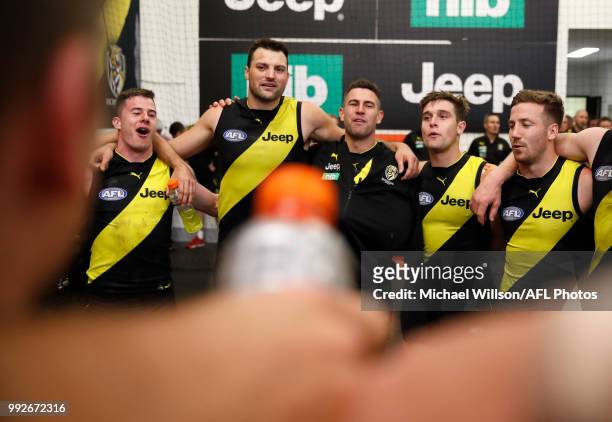 Tigers players sing the team song during the 2018 AFL round 16 match between the Richmond Tigers and the Adelaide Crows at the Melbourne Cricket...