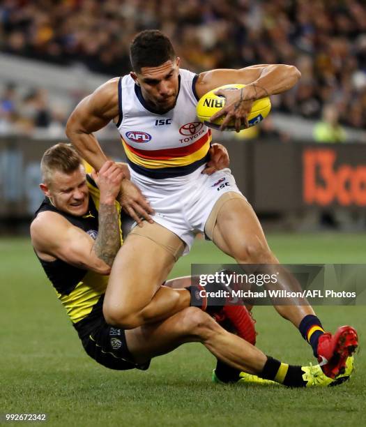 Curtly Hampton of the Crows is tackled by Brandon Ellis of the Tigers during the 2018 AFL round 16 match between the Richmond Tigers and the Adelaide...