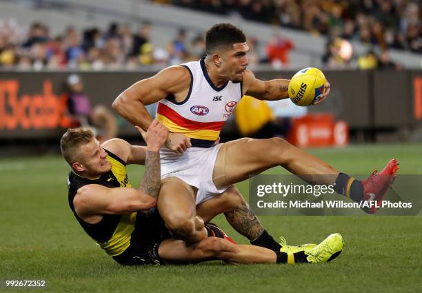 Curtly Hampton of the Crows is tackled by Brandon Ellis of the Tigers during the 2018 AFL round 16 match between the Richmond Tigers and the Adelaide...