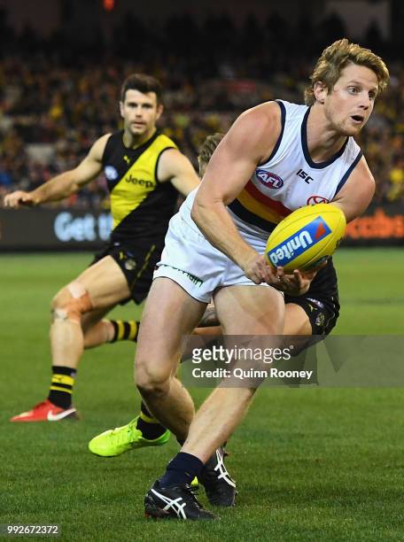 Rory Sloane of the Crows handballs during the round 16 AFL match between the Richmond Tigers and the Adelaide Crows at Melbourne Cricket Ground on...