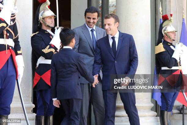 Qatar Sheikh Tamim bin Hamad Al Thani introduces his son Hamad to French president Emmanuel Macron upon arrival at the Elysee palace on July 6 in...