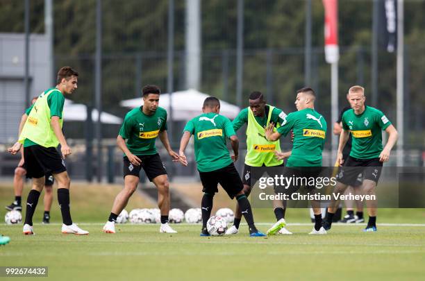 Ibrahima Traore, Raffael and Laszlo Benes battle for the ball during a training session of Borussia Moenchengladbach at Borussia-Park on July 05,...
